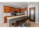 Kitchen with breakfast bar featuring granite countertops, tile floors and stainless appliances at 13830 Trull Way, Hudson, FL 34669