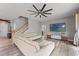 Bright living room featuring a staircase and a wall-mounted TV at 13830 Trull Way, Hudson, FL 34669