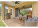 Covered patio with stainless steel grill, ceiling fan, and comfortable outdoor seating at 13830 Trull Way, Hudson, FL 34669