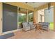 Covered patio area with stylish seating, ceiling fan, and sliding glass doors to the house at 13830 Trull Way, Hudson, FL 34669