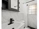 Tastefully updated bathroom featuring sleek fixtures, patterned tile, and a clean aesthetic, providing a relaxing retreat at 1512 Hillside Dr, Tampa, FL 33610