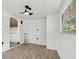 Bright bedroom features a ceiling fan, wood-look flooring, and a big window, creating a cozy and inviting retreat at 1512 Hillside Dr, Tampa, FL 33610