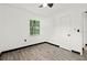 Bright bedroom features durable wood-look flooring, ceiling fan, and a window providing natural light at 1512 Hillside Dr, Tampa, FL 33610