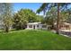 Inviting home featuring lush green lawn, mature trees, and charming curb appeal, perfect for outdoor enjoyment at 1512 Hillside Dr, Tampa, FL 33610