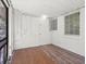 The screened porch features wood-look flooring, white walls, and multiple windows for great natural light at 1512 Hillside Dr, Tampa, FL 33610