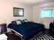 Serene bedroom featuring a comfortable bed, ample natural light, and stylish décor at 1605 Mission Hills Blvd # D5, Clearwater, FL 33759