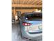 View of the carport showing a newer model SUV and storage in back at 1605 Mission Hills Blvd # D5, Clearwater, FL 33759