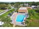 Aerial view of the community pool featuring lounge chairs and lush surroundings at 1605 Mission Hills Blvd # D5, Clearwater, FL 33759