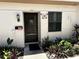 Charming home entrance featuring a well-maintained door, decorative accents, and surrounding greenery at 1605 Mission Hills Blvd # D5, Clearwater, FL 33759