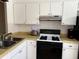 Functional kitchen features an efficient layout with sleek appliances and practical cabinetry at 1605 Mission Hills Blvd # D5, Clearwater, FL 33759