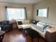 Comfortable living room featuring a plush sectional sofa, natural light, and decorative accents at 1605 Mission Hills Blvd # D5, Clearwater, FL 33759