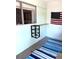 Enclosed porch with bright decor, offering additional versatile space for leisure or storage at 1605 Mission Hills Blvd # D5, Clearwater, FL 33759