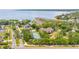 Aerial view showcasing waterfront condos with tennis courts and beautiful landscape at 163 Brent Cir, Oldsmar, FL 34677