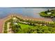 Aerial view of the community with manicured landscaping, pool, and waterfront access at 163 Brent Cir, Oldsmar, FL 34677