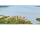 Aerial view of the waterfront condos surrounded by mature trees and beautiful views of the bay at 163 Brent Cir, Oldsmar, FL 34677