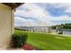 Scenic backyard view with lush lawn, a dock overlooking the water, and clear skies, perfect for relaxing at 163 Brent Cir, Oldsmar, FL 34677