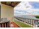 Relaxing balcony overlooking the water with seating, ceiling fan and a beautiful view at 163 Brent Cir, Oldsmar, FL 34677