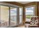 Balcony view overlooking serene water with a comfortable chair perfect for relaxation at 163 Brent Cir, Oldsmar, FL 34677