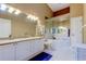 Bathroom featuring a jetted tub, double sinks, and white cabinetry at 163 Brent Cir, Oldsmar, FL 34677