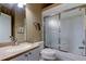 Bright bathroom featuring a shower-tub combination with sliding glass doors and a vanity at 163 Brent Cir, Oldsmar, FL 34677