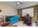 Cozy bedroom featuring a ceiling fan, a window bringing natural light, and a comfortable bed setup at 163 Brent Cir, Oldsmar, FL 34677