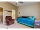 Comfortable bedroom with a ceiling fan, a cozy armchair, and an en-suite bathroom for added privacy at 163 Brent Cir, Oldsmar, FL 34677