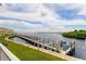Expansive waterfront views from the community dock with boat slips and lifts on a sunny day at 163 Brent Cir, Oldsmar, FL 34677