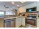 Contemporary kitchen with stainless steel appliances, white cabinets, and modern fixtures at 163 Brent Cir, Oldsmar, FL 34677