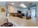 Modern kitchen features stainless steel appliances, white cabinetry, and breakfast bar at 163 Brent Cir, Oldsmar, FL 34677