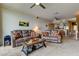 Spacious living room with plush sofas, ceiling fans and an open layout at 163 Brent Cir, Oldsmar, FL 34677