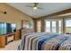 Well-lit primary bedroom featuring a ceiling fan, dresser, and access to a private balcony at 163 Brent Cir, Oldsmar, FL 34677