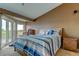 Spacious main bedroom featuring a ceiling fan, balcony access, and scenic views at 163 Brent Cir, Oldsmar, FL 34677