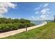 Scenic waterfront path surrounded by lush greenery and bright skies at 163 Brent Cir, Oldsmar, FL 34677