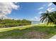 Waterfront view from a patio, showcasing lush landscaping and serene water views at 163 Brent Cir, Oldsmar, FL 34677