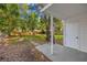 Backyard patio with a grill, surrounded by mature trees and a privacy fence, perfect for outdoor entertaining at 1752 42Nd S St, St Petersburg, FL 33711