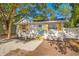 Single-story home with a light blue front door, light-colored gravel yard, and manicured landscaping at 1752 42Nd S St, St Petersburg, FL 33711