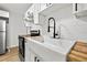 Close-up of the modern kitchen showcasing a farmhouse sink, butcher block countertops, and stylish black hardware at 1752 42Nd S St, St Petersburg, FL 33711