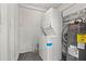 Functional laundry room features a stacked washer and dryer with a modern water heater at 1752 42Nd S St, St Petersburg, FL 33711