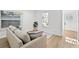 Cozy living room featuring neutral tones, hardwood floors, and a comfortable sofa with blue pillows at 1752 42Nd S St, St Petersburg, FL 33711