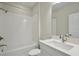 Modern bathroom featuring a shower-tub combination with white tiled walls at 17555 Glistening Ct, Venice, FL 34293