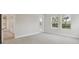 Bright bedroom featuring plush carpeting and views of the pool through a set of windows at 17555 Glistening Ct, Venice, FL 34293