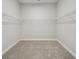 Walk-in closet with carpet flooring and ample shelving for storage at 17555 Glistening Ct, Venice, FL 34293