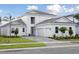 Beautiful house featuring a three-car garage, brick driveway and lush landscaping at 17555 Glistening Ct, Venice, FL 34293