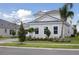 Charming home with lush landscaping, healthy green grass, and a concrete driveway at 17555 Glistening Ct, Venice, FL 34293