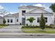 Beautiful two-story home with modern architecture, manicured landscaping and a brick paver driveway at 17555 Glistening Ct, Venice, FL 34293