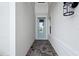 Charming front door with glass accents and a stylish exterior light fixture at 17555 Glistening Ct, Venice, FL 34293