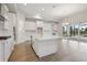 Modern kitchen with an island, stainless steel appliances, and white cabinetry at 17555 Glistening Ct, Venice, FL 34293