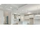 Open kitchen with white cabinetry, stainless steel appliances, and hardwood floors at 17555 Glistening Ct, Venice, FL 34293