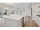 Bright kitchen with a large island, stainless steel appliances, and slider view to pool at 17555 Glistening Ct, Venice, FL 34293