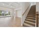 Bright living room boasts wood floors, coffered ceilings, and sliding glass doors to the outdoor pool area at 17555 Glistening Ct, Venice, FL 34293